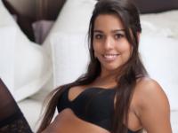 Latina female sports a smile on her pretty face while modeling in lingerie - Photo #1