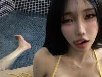 Cute South Korean girl uncovers her tits while posing in a bikini in a pool - Photo #2