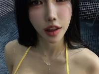 Cute South Korean girl uncovers her tits while posing in a bikini in a pool - Photo #3