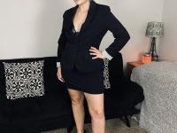 Older woman Lil Ms Muffet takes off her clothes while wearing glasses and heels - Photo #1