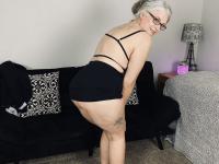 Older woman Lil Ms Muffet takes off her clothes while wearing glasses and heels - Photo #6