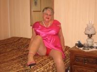 Silver haired nan Girdle Goddess pulls her hose down around her knees on a bed - Photo #5