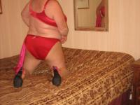 Silver haired nan Girdle Goddess pulls her hose down around her knees on a bed - Photo #11