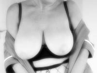Old woman with short hair and floppy tits dons a strapon in fishnet pantyhose - Photo #1