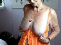 Platinum blonde granny takes off fluffy slippers before showing her saggy tits - Photo #14