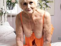 Platinum blonde granny takes off fluffy slippers before showing her saggy tits - Photo #16