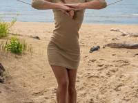 Tall teen Mina hangs wet clothes to dry while posing nude on a beach - Photo #1