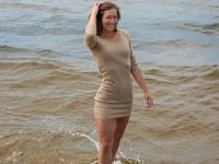 Tall teen Mina hangs wet clothes to dry while posing nude on a beach - Photo #2