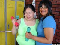 Older dyke Lily and horny gf share double dildo during sex in weight room - Photo #1