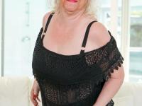 Naughty granny Vicky C strips down to her stockings & masturbates with a dildo - Photo #1