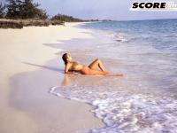 Busty MILF Devon Daniels gets her massive melons covered in sand at the beach - Photo #11