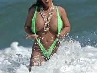 Big titted female Alicia Demarco shows her phat ass in surf wearing a V-bikini - Photo #1