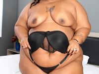 Ebony SSBBW discards black lingerie to get naked on top of a bed - Photo #4