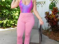 Thick amateur Dezire Tutto bares her large tits as she gets naked on a patio - Photo #1