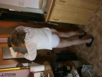 Hairy grandmother slides her upskirt panties aside to expose her vagina - Photo #9