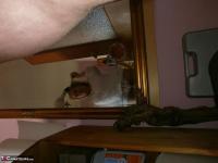Hairy grandmother slides her upskirt panties aside to expose her vagina - Photo #11