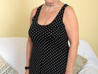Sexy granny Savana flashes upskirt underwear before unleashing her large boobs - Photo #1