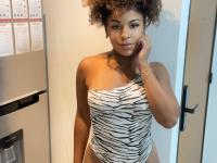 Ebony solo girl with a full head of curly hair models a lot of outfits - Photo #17