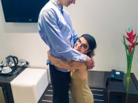 Mature midget with glasses Sara One strips and shows her big tits & ass - Photo #1