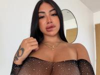 Dark haired beauty licks her lips while working a revealing bodystocking - Photo #1
