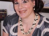 Mature lady strips off her clothing to pose nude in her living room - Photo #2