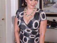 Mature lady strips off her clothing to pose nude in her living room - Photo #4
