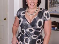 Mature lady strips off her clothing to pose nude in her living room - Photo #5