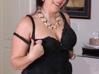 Mature lady strips off her clothing to pose nude in her living room - Photo #13