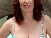 Mature redhead Viola lets out those naturals and poses on the outdoor bed - Photo #1