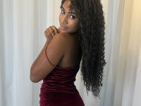 Cute ebony girl models a short red velvet dress as well as a black top and jeans - Photo #1