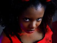 Pretty black girl Sukki T unveils her hairy pussy during a striptease on a bed - Photo #2