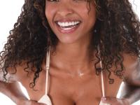 Ebony solo girl Barbie Rous uncovers her big tits before showing her bald pussy - Photo #4