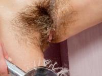 Pretty petite babe Mia plays with her hairy pussy in the bathroom - Photo #8