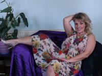 Older blonde woman blows a kiss after stripping to her jewelry - Photo #4