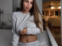 Amateur female with a nice set of breasts uncups them over her sweatpants - Photo #3