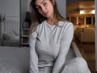 Amateur female with a nice set of breasts uncups them over her sweatpants - Photo #5