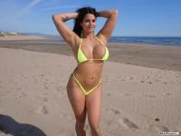 Curvy girl Chloe Lamour sets her big fake tits free of a bikini at the beach - Photo #1