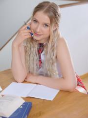 Blonde teen Lilly gets completely naked while studying at a desk