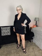 Older woman Lil Ms Muffet takes off her clothes while wearing glasses and heels