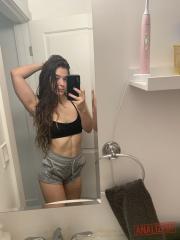 Amateur model holds her bare ass during a series of nude selfies