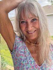 Skinny blonde granny Leilani toys her shaved pussy using a glass dildo