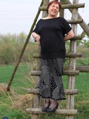 Redhead granny Sheila reveals her swollen vagina on an outdoor ladder