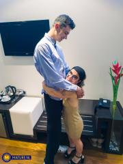 Mature midget with glasses Sara One strips and shows her big tits & ass
