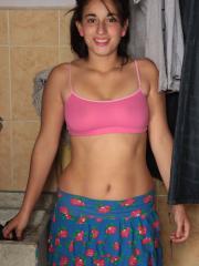 Horny teen with pigtails Roxane exposes her big ass and natural breasts