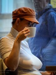 Amateur girl exposes her big tits while out in public in a cap and glasses