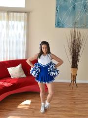 Foxy cheerleader Cassidy Klein pulling up her dress to unveil her bushy clam