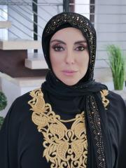 Busty MILF Kylie Kingston gets banged by a boy on a sofa while wearing a hijab