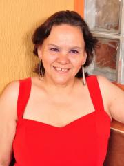 Overweight Latin housewife takes off red dress to pose in lingerie and hose