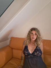 Mature blonde woman models lingerie at home during a solo performance