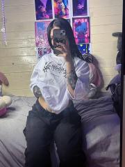 Brunette teen takes selfies while stripping to her thong on a bed